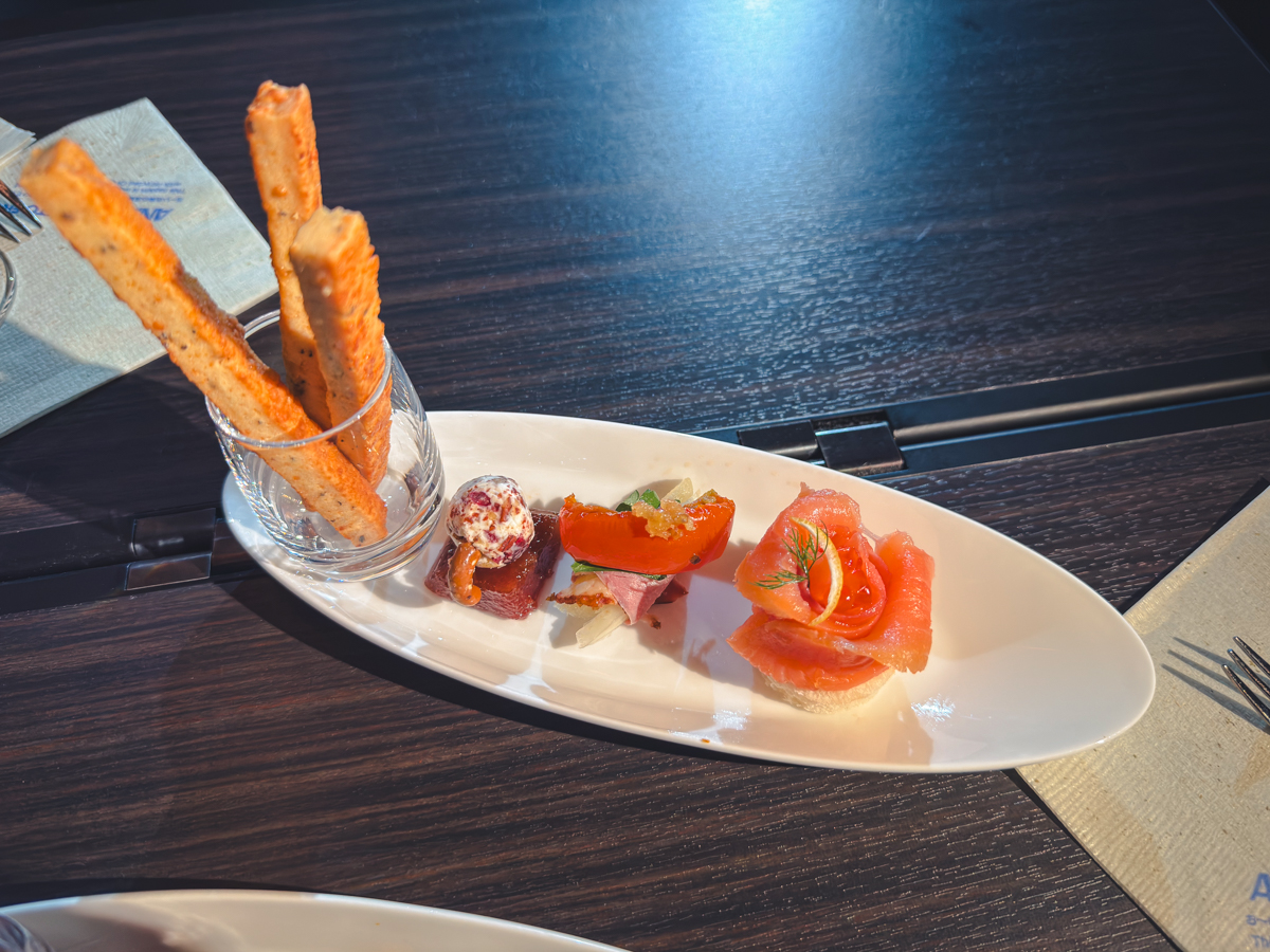 ANA Amuse Bouche with smoked salmon, seared duck, and cheese/