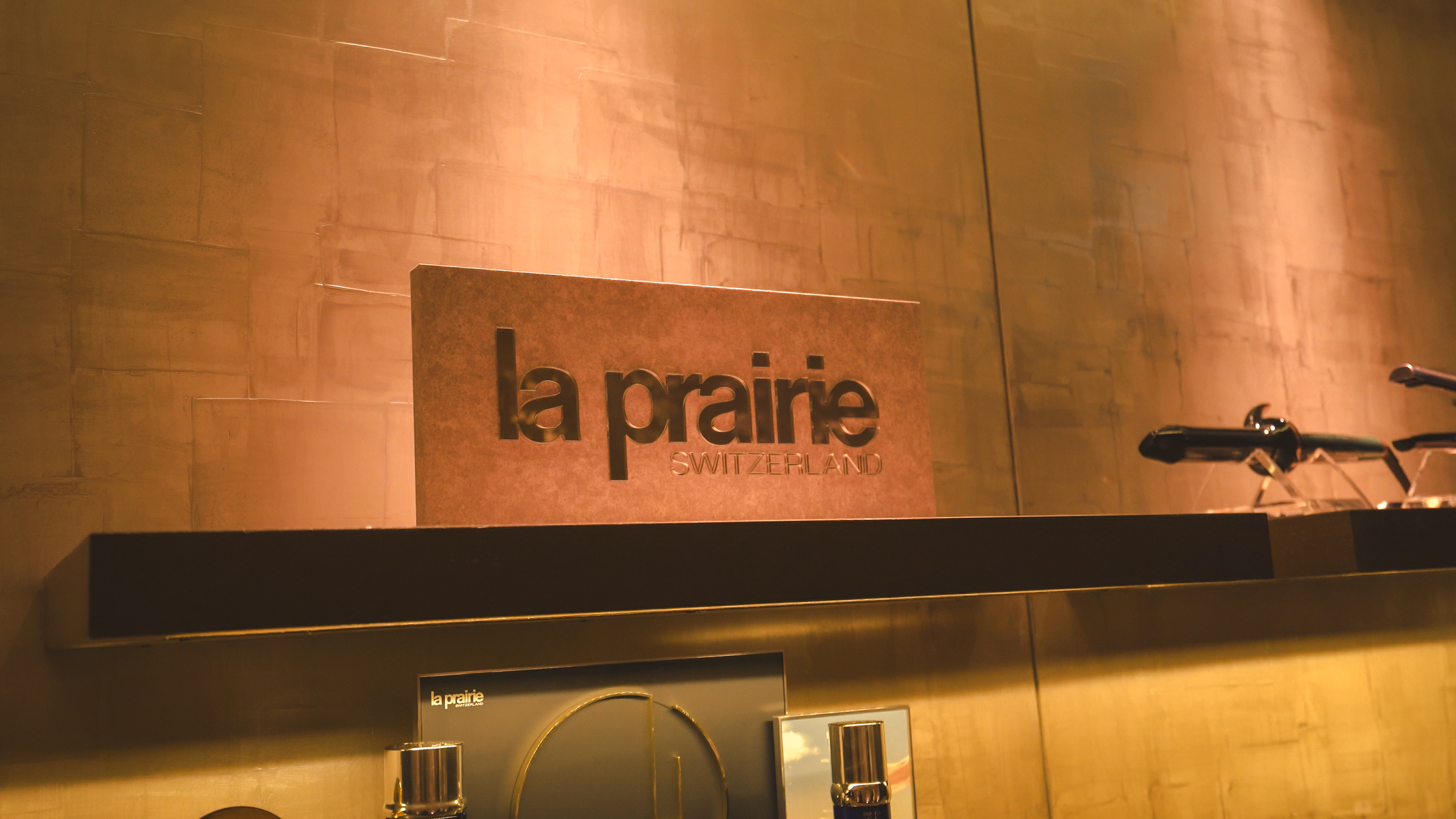 la prairie sign and skincare products for sale on a shelf.