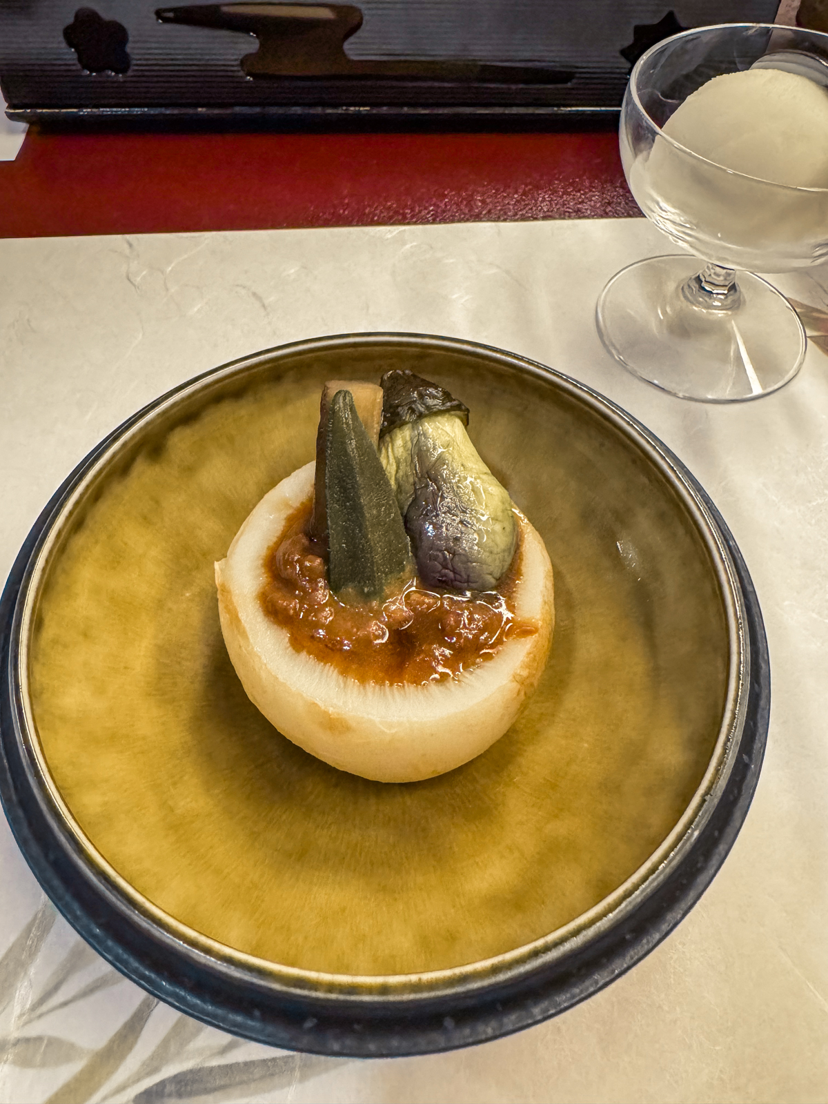 Minced beef with small eggplant, okra in a turnip bowl.