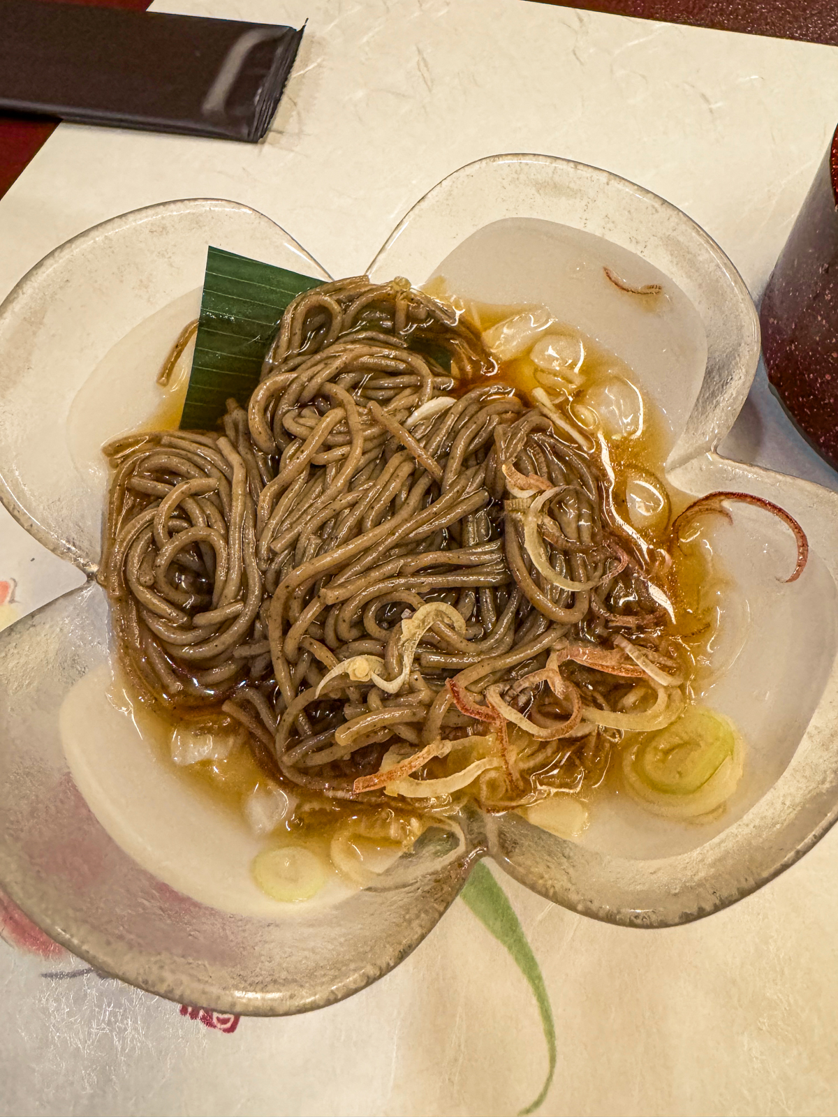 Dashi poured into bowl of cold soba noodles.