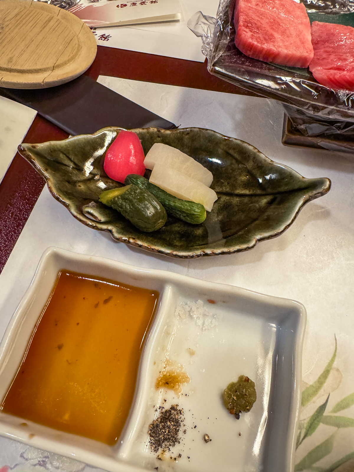 Japanese pickles with dipping sauce and salts.