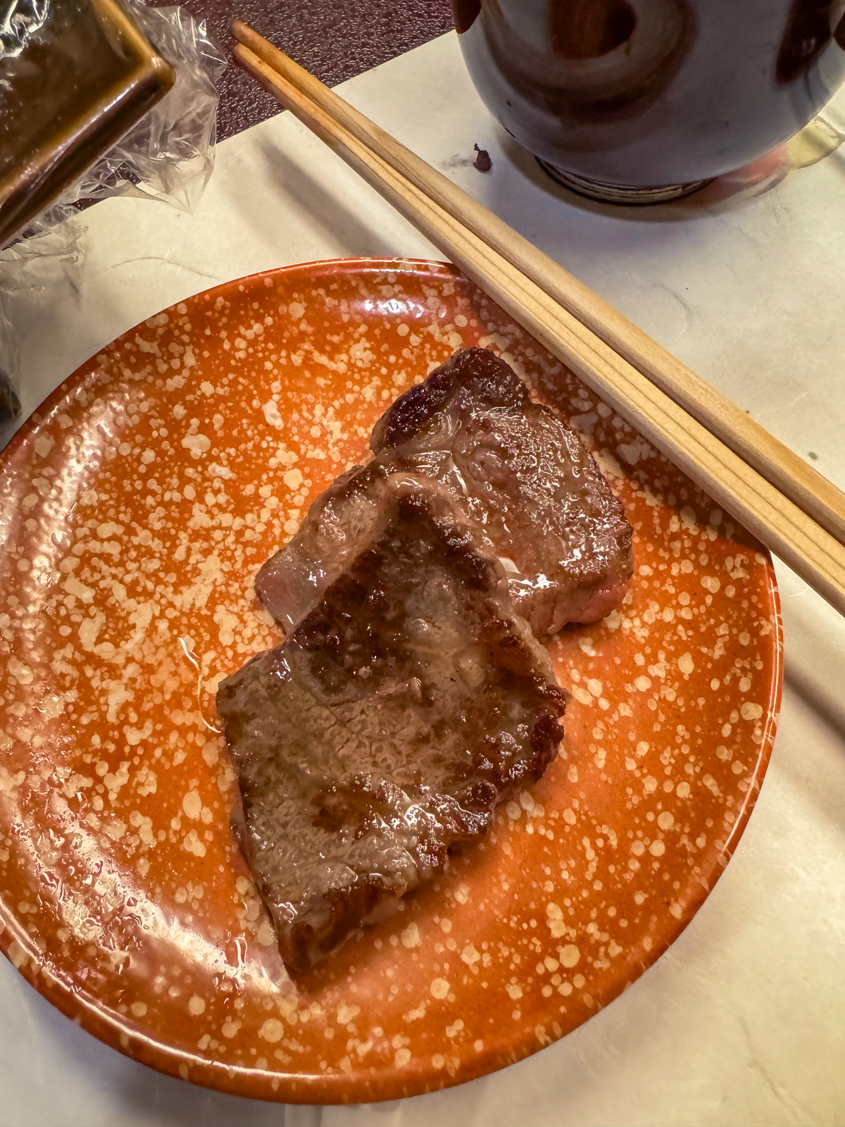 2 perfectly cooked pieces of wagyu beef on a plate.